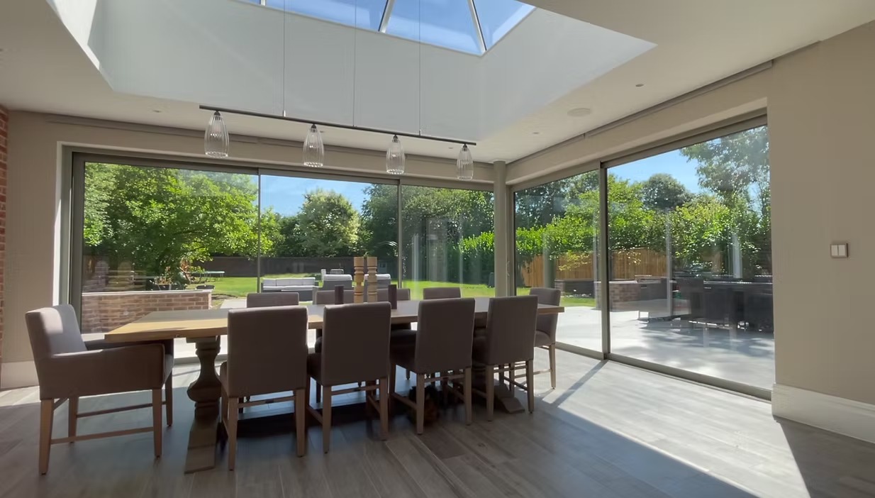 Completed blind and curtain installation over large glazing by Curtain & Blind Design