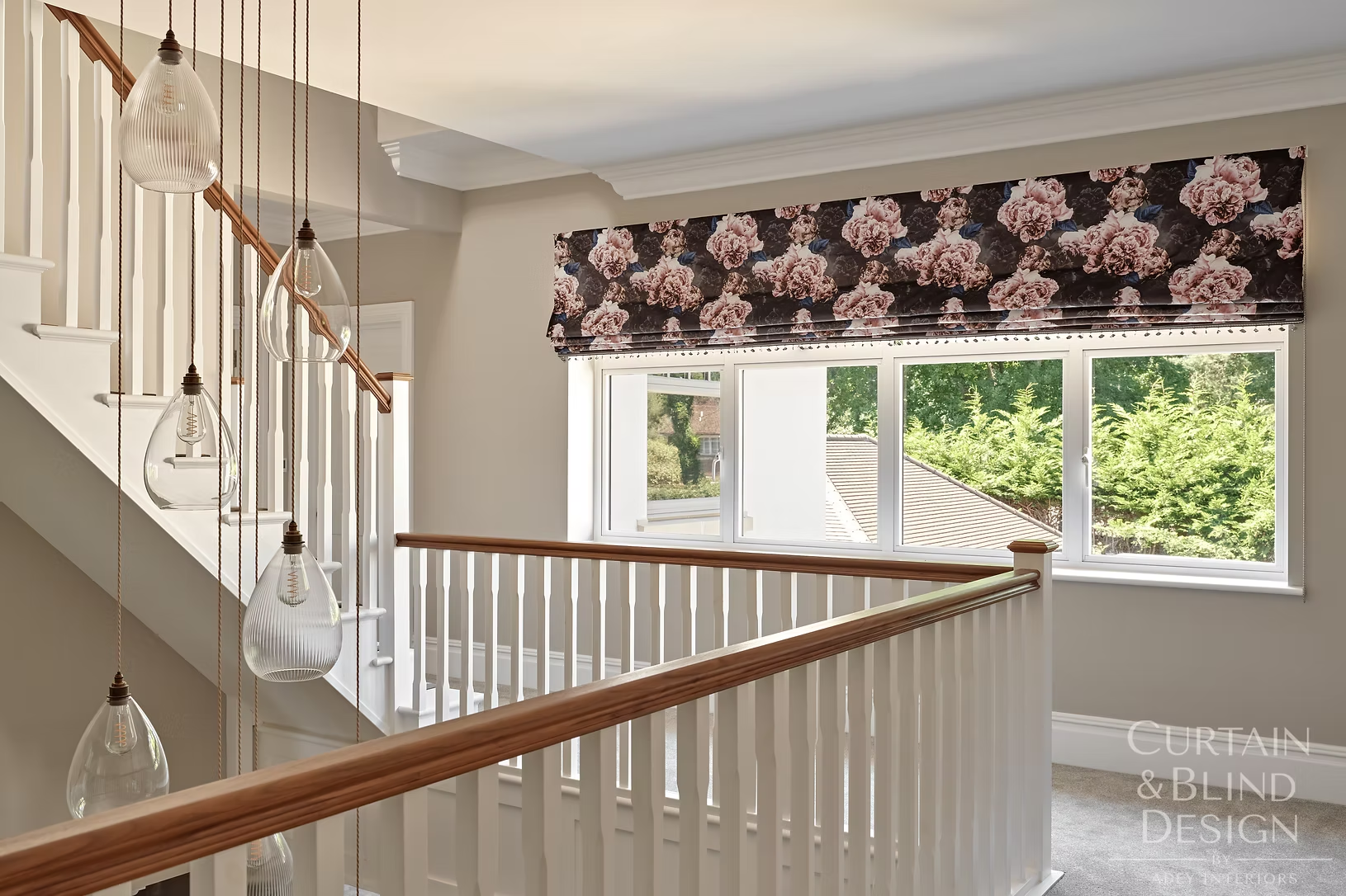 Floral Roman blind fitted to a wide landing window above a staircase