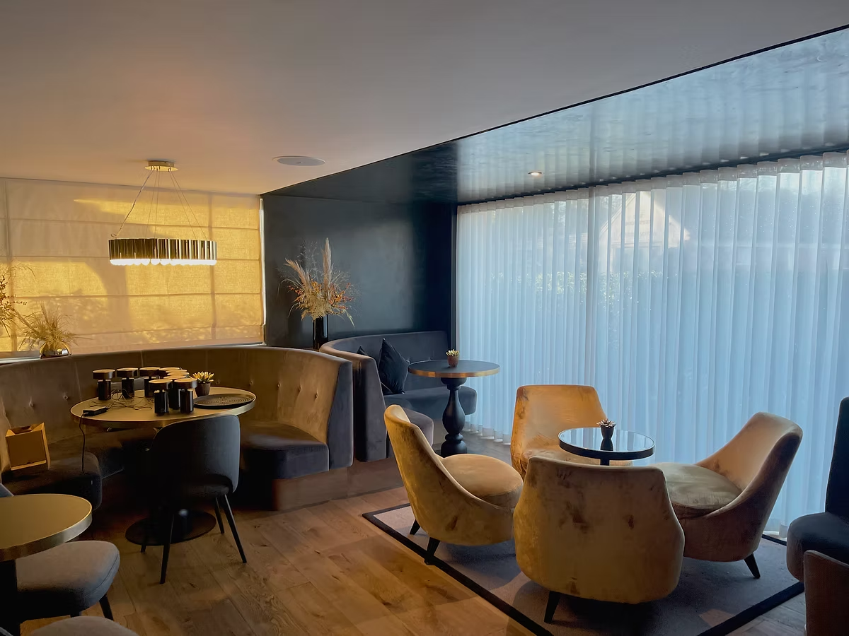 Large translucent voile window treatment in a hospitality lounge and dining space