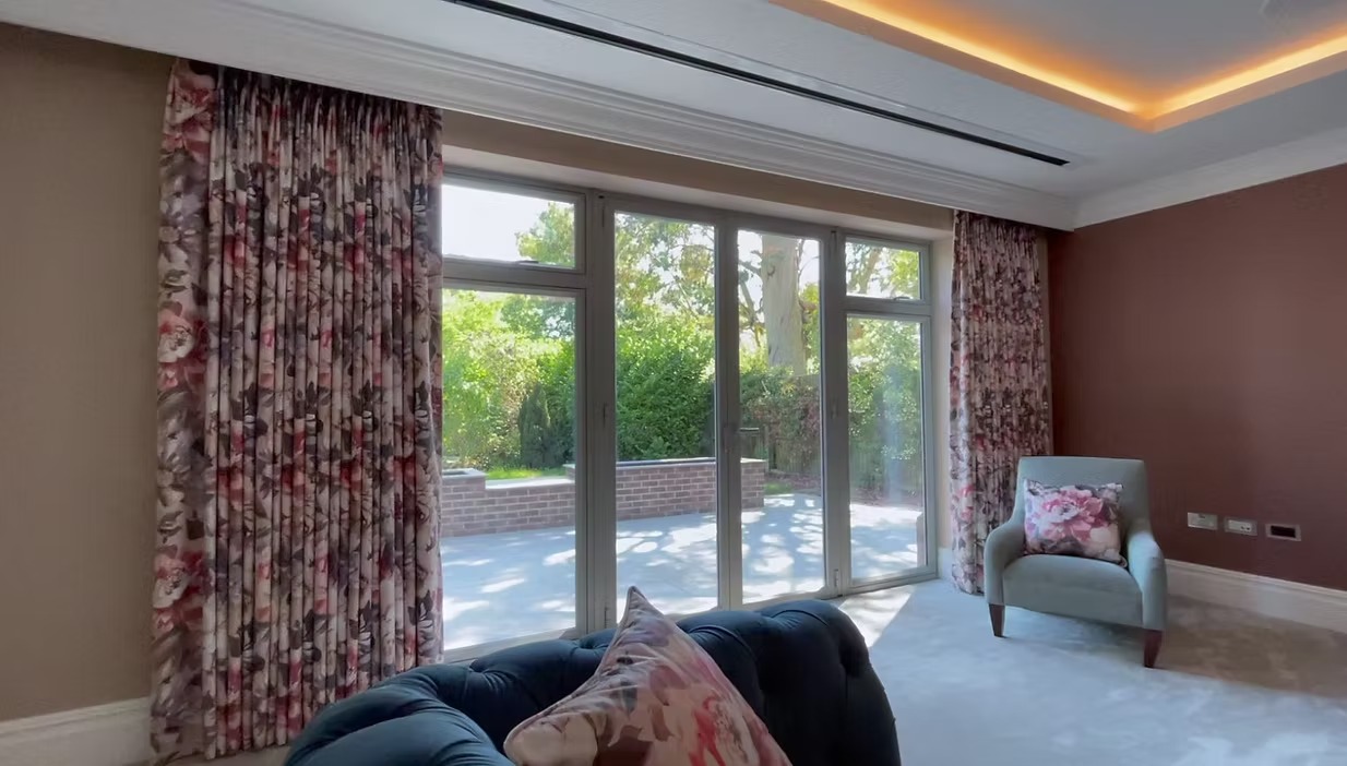Completed blind and curtain installation over large glazing by Curtain & Blind Design