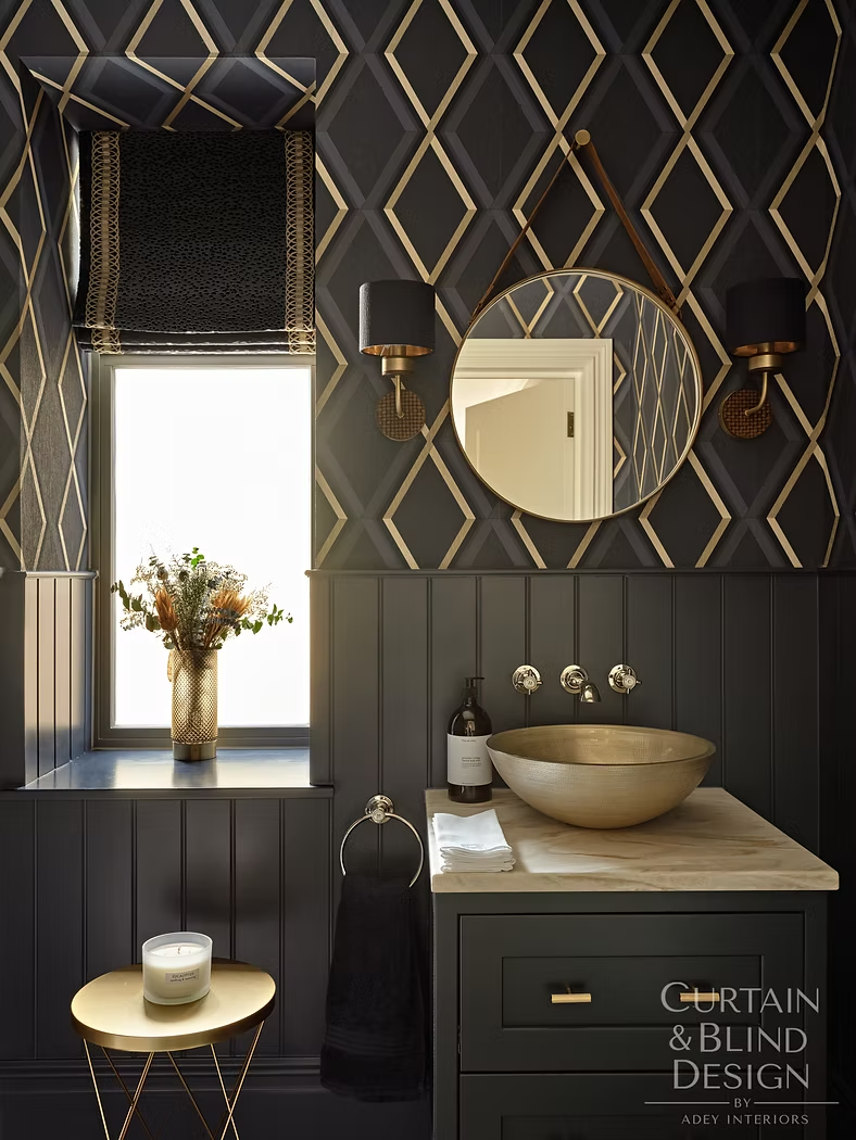 Black Roman blind against geometric wallpaper in a dark guest bathroom