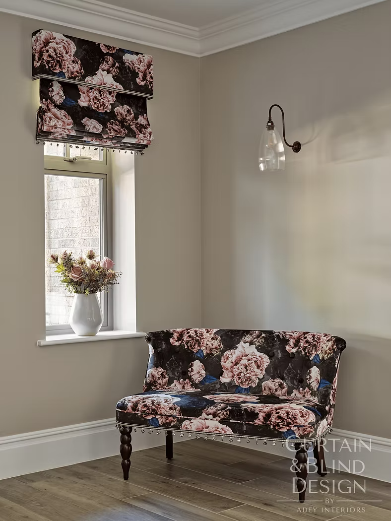 Floral Roman blind and matching upholstered loveseat in a house entrance