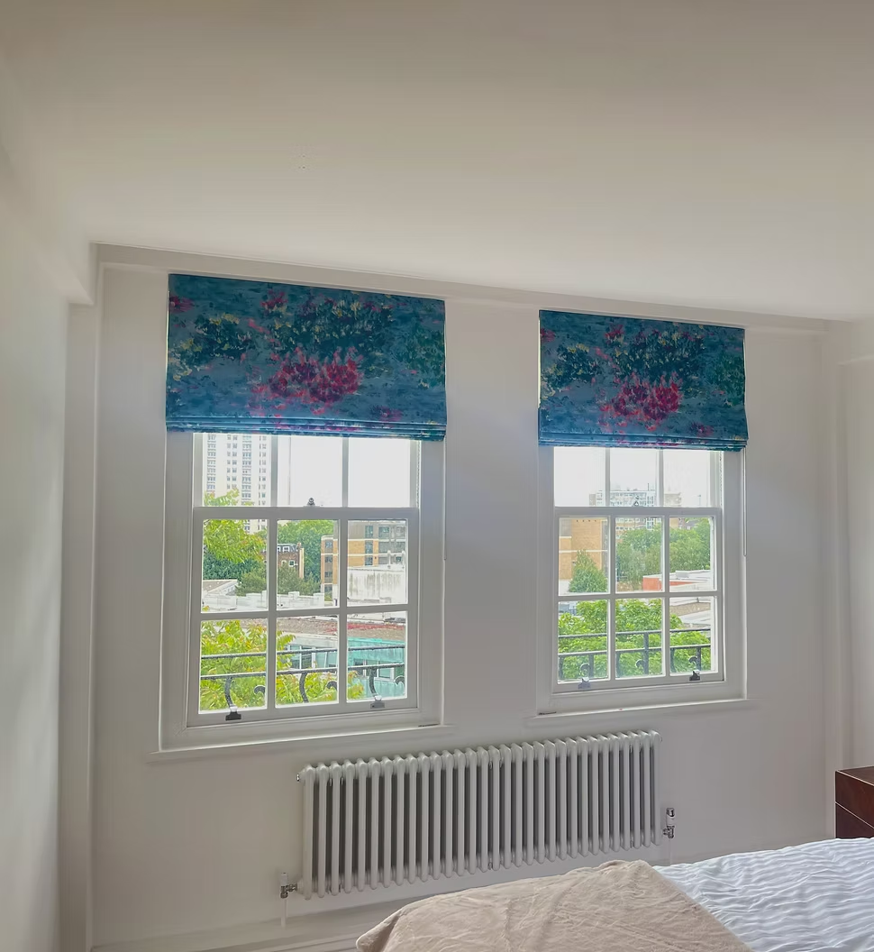 Pair of patterned Roman blinds fitted to bedroom sash windows